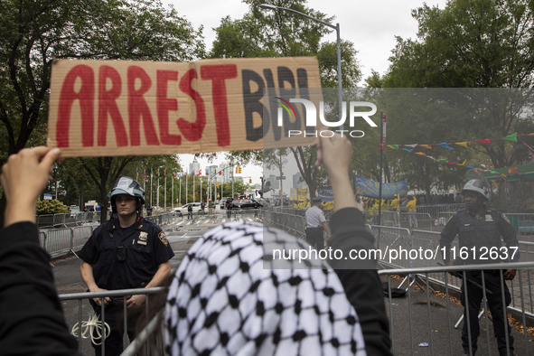 A pro-Palestinian demonstrator shows a sign with the words ''Arrest Bibi'' during a protest in front of the United Nations (UN) headquarters...