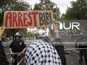 A pro-Palestinian demonstrator shows a sign with the words ''Arrest Bibi'' during a protest in front of the United Nations (UN) headquarters...