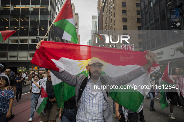 A person holds a Lebanese flag during a pro-Palestinian protest in New York City, USA, on September 26, 2024. Hundreds gather for demonstrat...