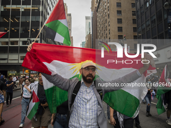 A person holds a Lebanese flag during a pro-Palestinian protest in New York City, USA, on September 26, 2024. Hundreds gather for demonstrat...