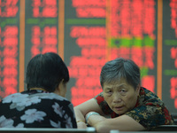 A customer pays attention to the stock market at a stock exchange in Hangzhou, China, on September 27, 2024. On the same day, affected by th...