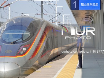 A staff member receives and departs a train on the platform at Fushan Station in Yantai, China, on September 27, 2024. As of September 14, 2...