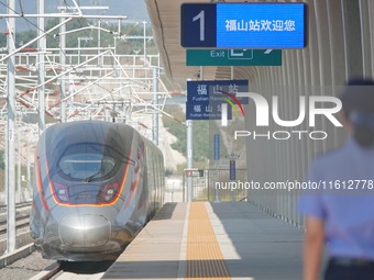 A staff member receives and departs a train on the platform at Fushan Station in Yantai, China, on September 27, 2024. As of September 14, 2...