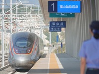 A staff member receives and departs a train on the platform at Fushan Station in Yantai, China, on September 27, 2024. As of September 14, 2...