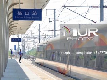 A staff member receives and departs a train on the platform at Fushan Station in Yantai, China, on September 27, 2024. As of September 14, 2...