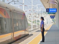 A staff member receives and departs a train on the platform at Fushan Station in Yantai, China, on September 27, 2024. As of September 14, 2...