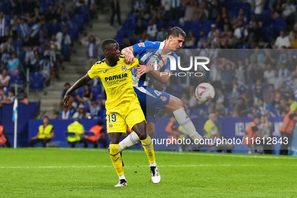 Marash Kubulla of Espanyol challenges Nicolas Pepe of Villarreal for the ball during the La Liga EA SPORTS match at Stage Front Stadium, in...