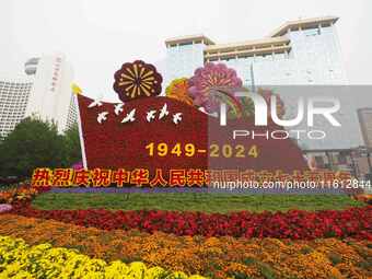 National Day themed flower beds are displayed along Chang'an Avenue in Beijing, China, on September 27, 2024. (