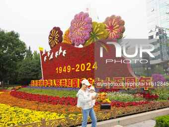 National Day themed flower beds are displayed along Chang'an Avenue in Beijing, China, on September 27, 2024. (