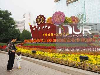 National Day themed flower beds are displayed along Chang'an Avenue in Beijing, China, on September 27, 2024. (