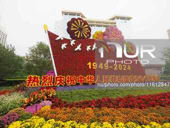 National Day themed flower beds are displayed along Chang'an Avenue in Beijing, China, on September 27, 2024. (