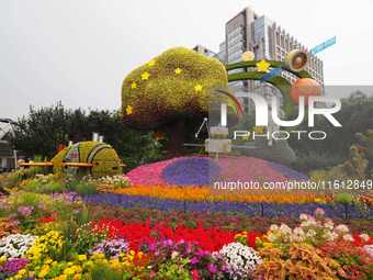 National Day themed flower beds are displayed along Chang'an Avenue in Beijing, China, on September 27, 2024. (