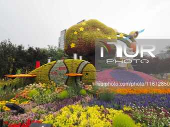 National Day themed flower beds are displayed along Chang'an Avenue in Beijing, China, on September 27, 2024. (