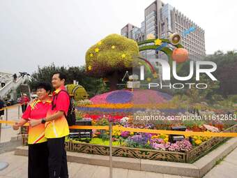 National Day themed flower beds are displayed along Chang'an Avenue in Beijing, China, on September 27, 2024. (