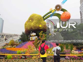 National Day themed flower beds are displayed along Chang'an Avenue in Beijing, China, on September 27, 2024. (