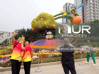 National Day themed flower beds are displayed along Chang'an Avenue in Beijing, China, on September 27, 2024. (