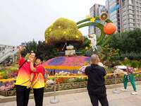 National Day themed flower beds are displayed along Chang'an Avenue in Beijing, China, on September 27, 2024. (