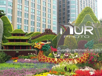 National Day themed flower beds are displayed along Chang'an Avenue in Beijing, China, on September 27, 2024. (