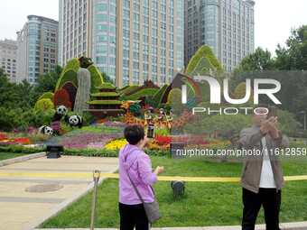 National Day themed flower beds are displayed along Chang'an Avenue in Beijing, China, on September 27, 2024. (