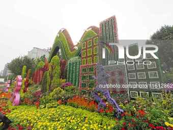 National Day themed flower beds are displayed along Chang'an Avenue in Beijing, China, on September 27, 2024. (