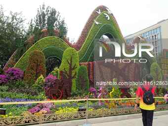 National Day themed flower beds are displayed along Chang'an Avenue in Beijing, China, on September 27, 2024. (