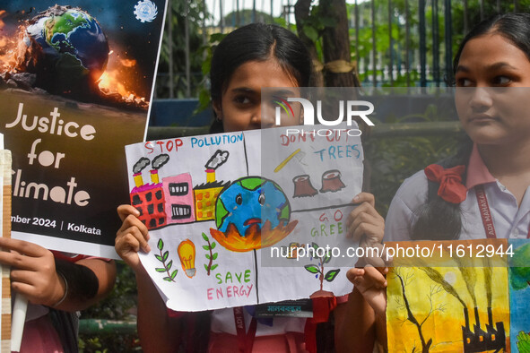 Students display their paintings dedicated to the protection of the global climate during the Global Climate Strike 2024 in Kolkata, India,...