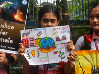 Students display their paintings dedicated to the protection of the global climate during the Global Climate Strike 2024 in Kolkata, India,...