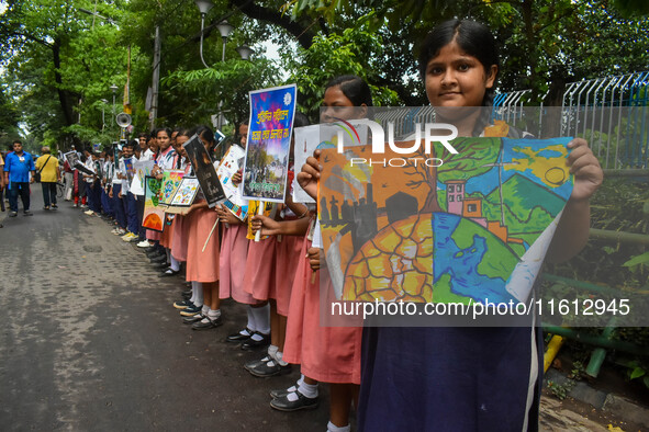 Students display their paintings dedicated to the protection of the global climate during the Global Climate Strike 2024 in Kolkata, India,...