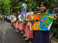 Students display their paintings dedicated to the protection of the global climate during the Global Climate Strike 2024 in Kolkata, India,...