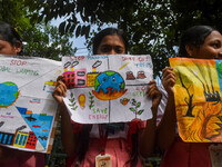 Students display their paintings dedicated to the protection of the global climate during the Global Climate Strike 2024 in Kolkata, India,...