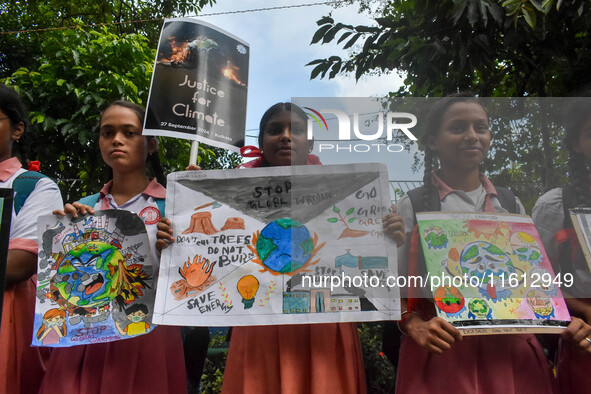 Students display their paintings dedicated to the protection of the global climate during the Global Climate Strike 2024 in Kolkata, India,...