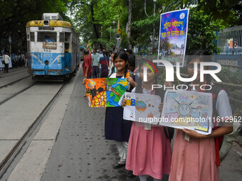 Students display their paintings dedicated to the protection of the global climate during a protest demonstration on Global Climate Strike 2...