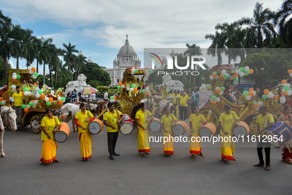 Dhakis play Dhak in front of Victoria Memorial Hall during the observation of World Tourism Day in Kolkata, India, on September 27, 2024. 