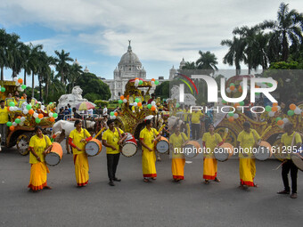 Dhakis play Dhak in front of Victoria Memorial Hall during the observation of World Tourism Day in Kolkata, India, on September 27, 2024. (