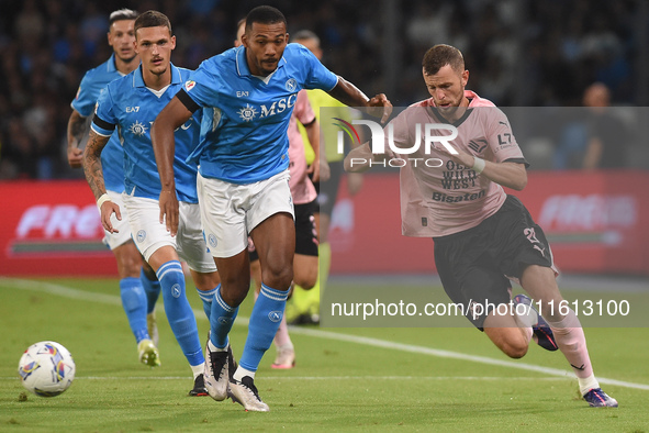 Jeremy Le Douaron of Palermo FC competes for the ball with Juan Jesus of SSC Napoli during the Coppa Italia match between SSC Napoli and Pal...