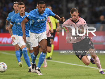 Jeremy Le Douaron of Palermo FC competes for the ball with Juan Jesus of SSC Napoli during the Coppa Italia match between SSC Napoli and Pal...