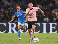 Kristoffer Lund of Palermo FC competes for the ball with Stanislav Lobotka of SSC Napoli during the Coppa Italia match between SSC Napoli an...