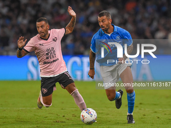 Roberto Insigne of Palermo FC competes for the ball with Leonardo Spinazzola of SSC Napoli during the Coppa Italia match between SSC Napoli...