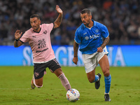 Roberto Insigne of Palermo FC competes for the ball with Leonardo Spinazzola of SSC Napoli during the Coppa Italia match between SSC Napoli...