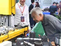 Buyers visit production equipment at the 17th China Handan (Yongnian) Fastener and Equipment Exhibition in Handan, Hebei province, China, on...