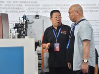 An exhibitor introduces production equipment to a buyer at the 17th China Handan (Yongnian) Fastener and Equipment Exhibition in Handan, Chi...