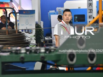 Buyers shop for production equipment at the 17th China Handan (Yongnian) Fasteners and Equipment Exhibition in Handan, China, on September 2...