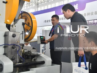 Buyers shop for production equipment at the 17th China Handan (Yongnian) Fasteners and Equipment Exhibition in Handan, China, on September 2...