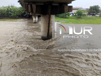 The water level of the Mahananda River rises during continuous rainfall in Siliguri, India, on September 27, 2024. (