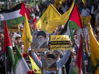 Iranian worshippers carry an anti-Israeli placard and portraits of Iran's Supreme Leader, Ayatollah Ali Khamenei, during an anti-Israeli pro...