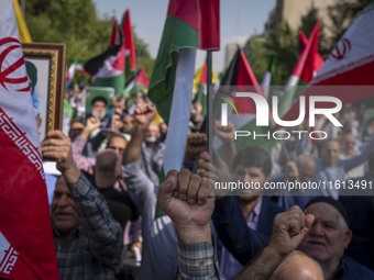 Iranian worshippers shout anti-Israel and anti-U.S. slogans while taking part in an anti-Israeli protest to condemn Israel's military attack...