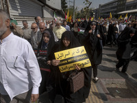 A veiled Iranian worshipper carries an anti-Israeli placard while taking part in an anti-Israeli protest to condemn Israel's military attack...