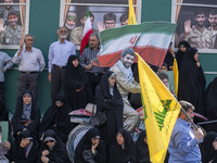 Iranian worshippers stand in front of symbolic portraits of Iranian warriors during an anti-Israeli protest to condemn Israel's military att...