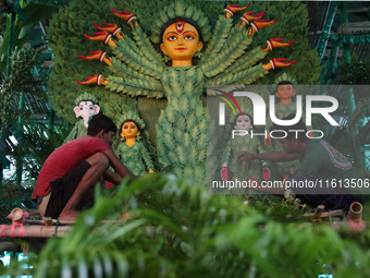 Artisans decorate an idol of the Hindu goddess Durga with eight thousand natural plants to raise awareness about global deforestation, clima...