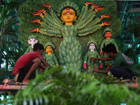 Artisans decorate an idol of the Hindu goddess Durga with eight thousand natural plants to raise awareness about global deforestation, clima...